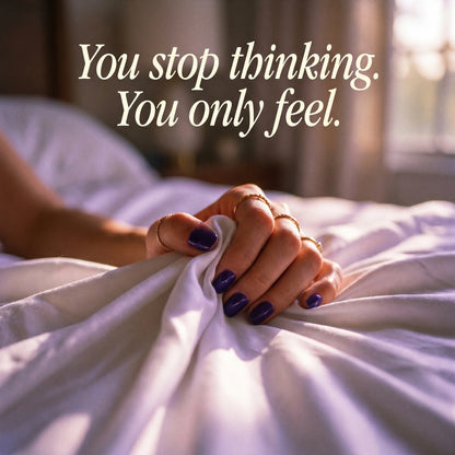 Person holding white sheets with a quote about thinking and feeling, in a softly lit bedroom.